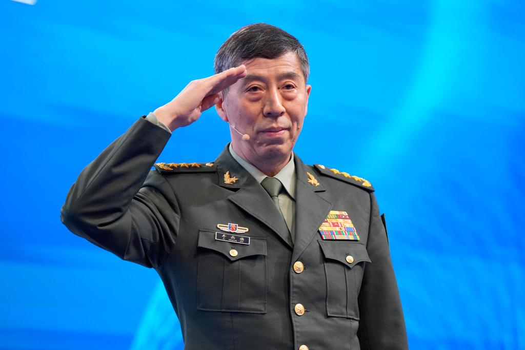 Chinese Defense Minister Li Shangfu salutes before delivering his speech on the last day of the 20th International Institute for Strategic Studies (IISS) Shangri-La Dialogue, Asia's annual defense and security forum, in Singapore
