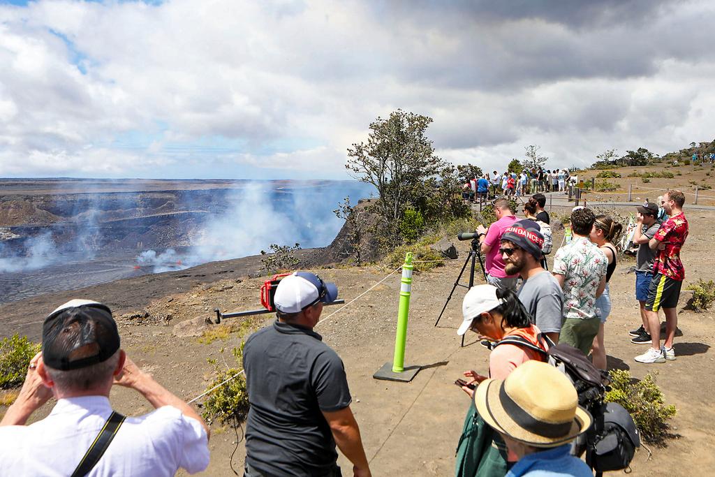 Visitors line the side of an overlook to view the Kilauea eruption in Hawaii