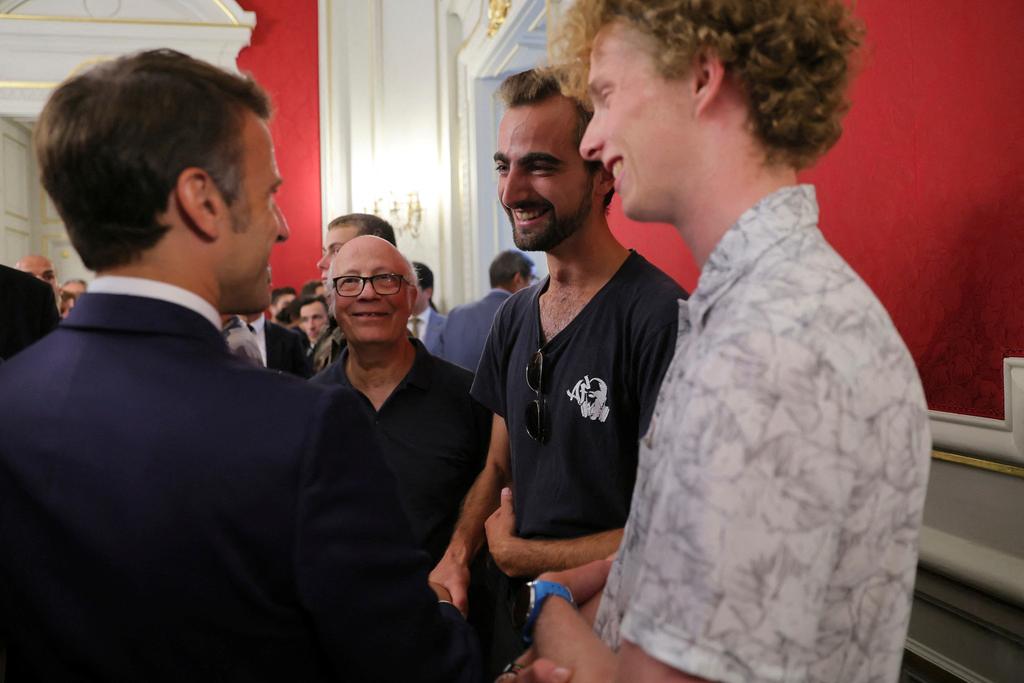 French President Emmanuel Macron meets Henri, second right, the 24-year-old 'backpack hero', his friend Lilian and Youssouf, who suffered minor stab wounds as he tried to intercept the suspect as he fled, in Annecy, French Alps