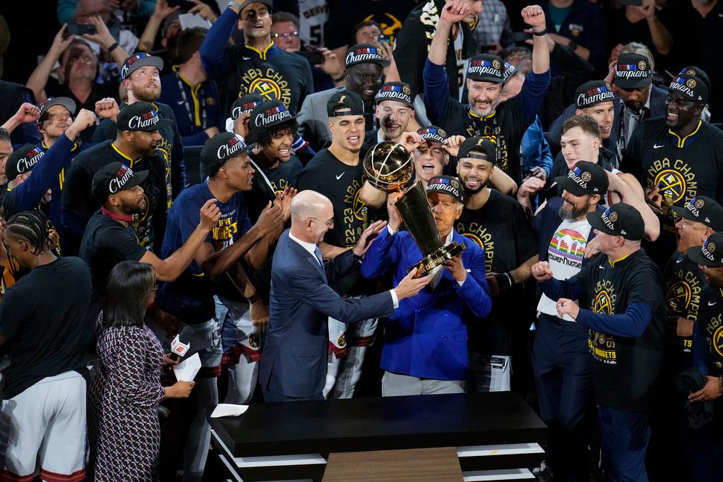 Denver Nuggets players, coaches and owners pose with the Larry O'Brien NBA Championship Trophy after their victory over the Miami Heat in Game 5 of basketball's NBA Finals