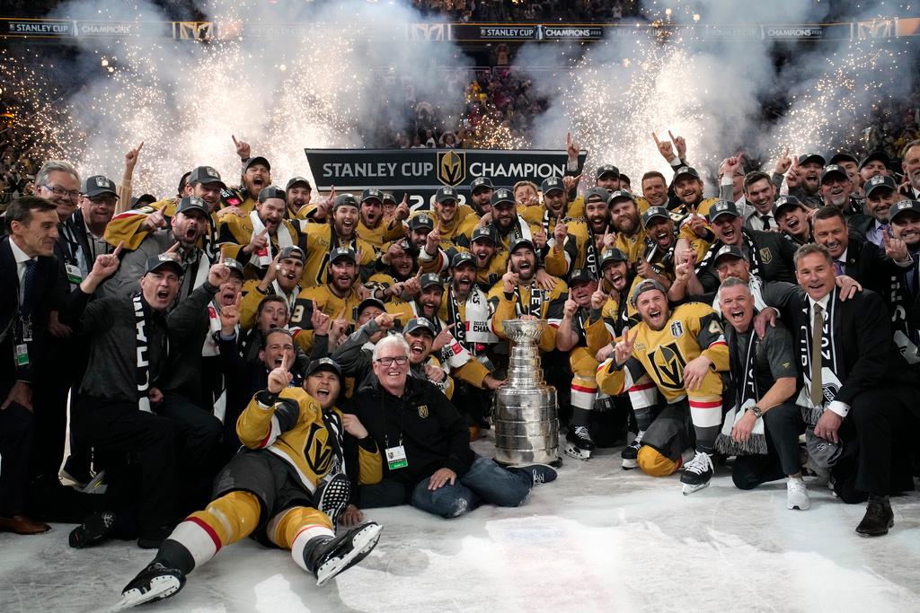 Members of the Vegas Golden Knights pose with the Stanley Cup after the Knights defeated the Florida Panthers 9-3 in Game 5 of the NHL hockey Stanley Cup Finals
