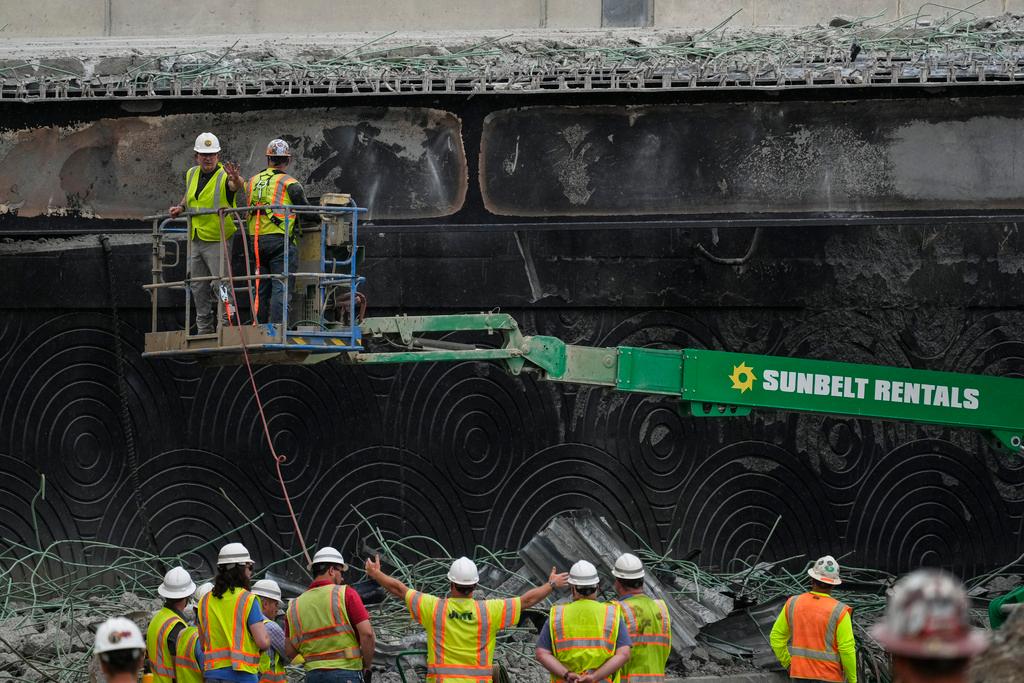 Crews continue to work the scene of a collapsed elevated section of Interstate 95