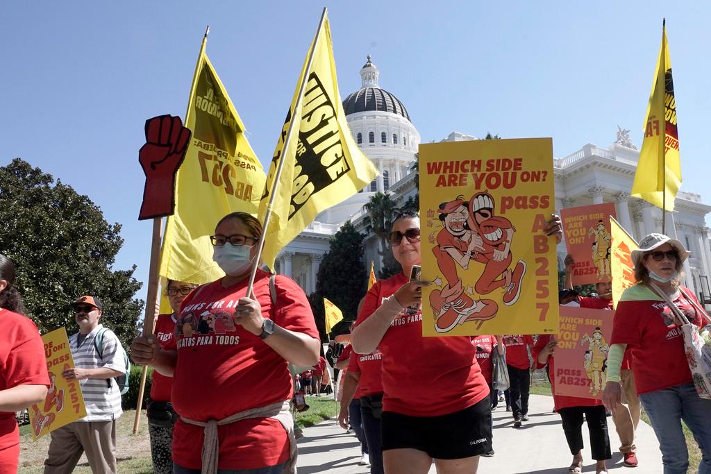 Fast food workers and their supporters march past the California state Capitol in Sacramento