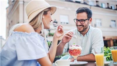 Two people sharing a sundae