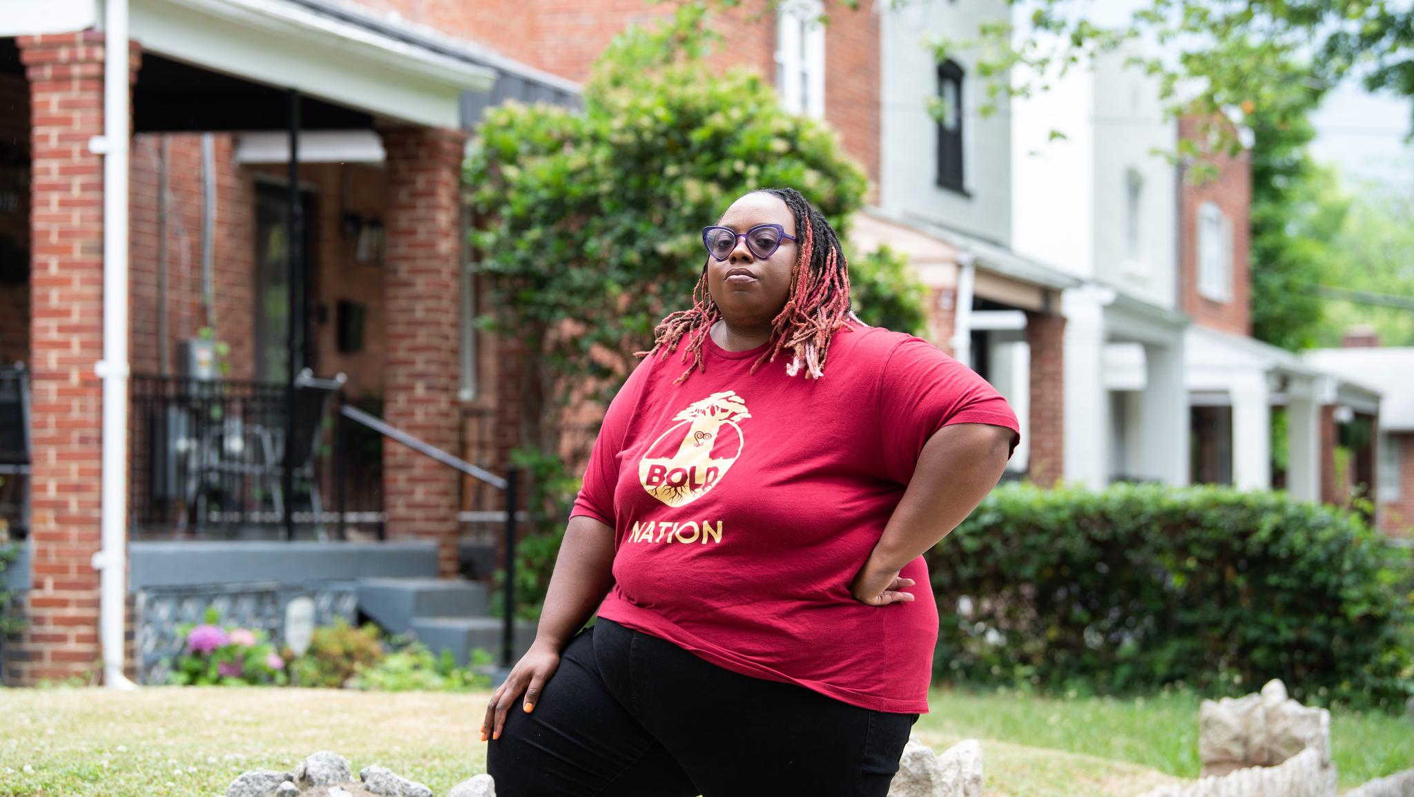 Woman with red t-shirt standing in front of her Washington home