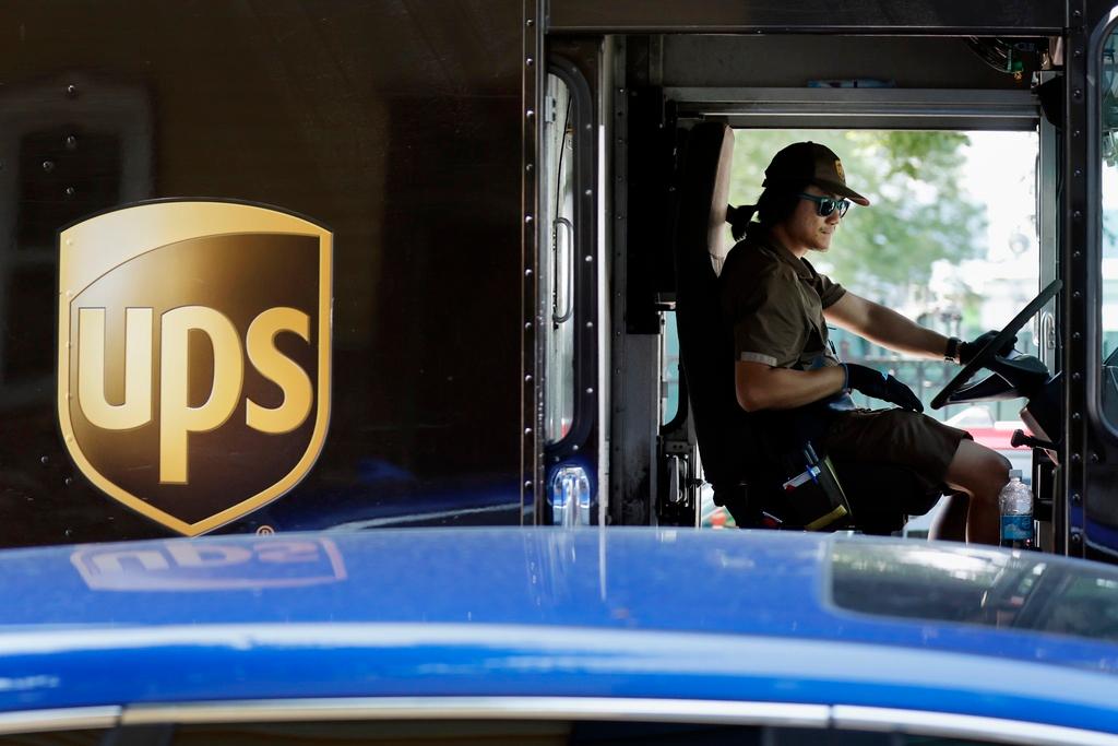 A United Parcel Service delivery driver steers his truck