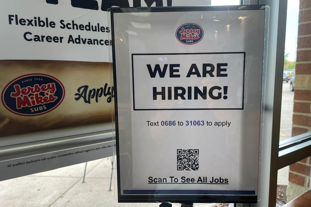 Hiring sign is displayed at a restaurant in Mount Prospect, Ill.
