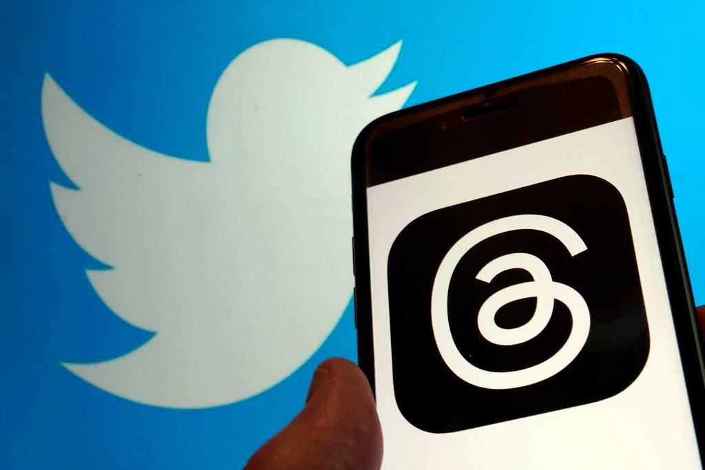 This photo, taken in New York on July 5, 2023, show the logo for Meta's new app Threads, right, and that of Twitter. In a cease-and-desist letter earlier this week, Twitter threatened legal action against Instagram parent company Meta over the new text-based app, Threads.
