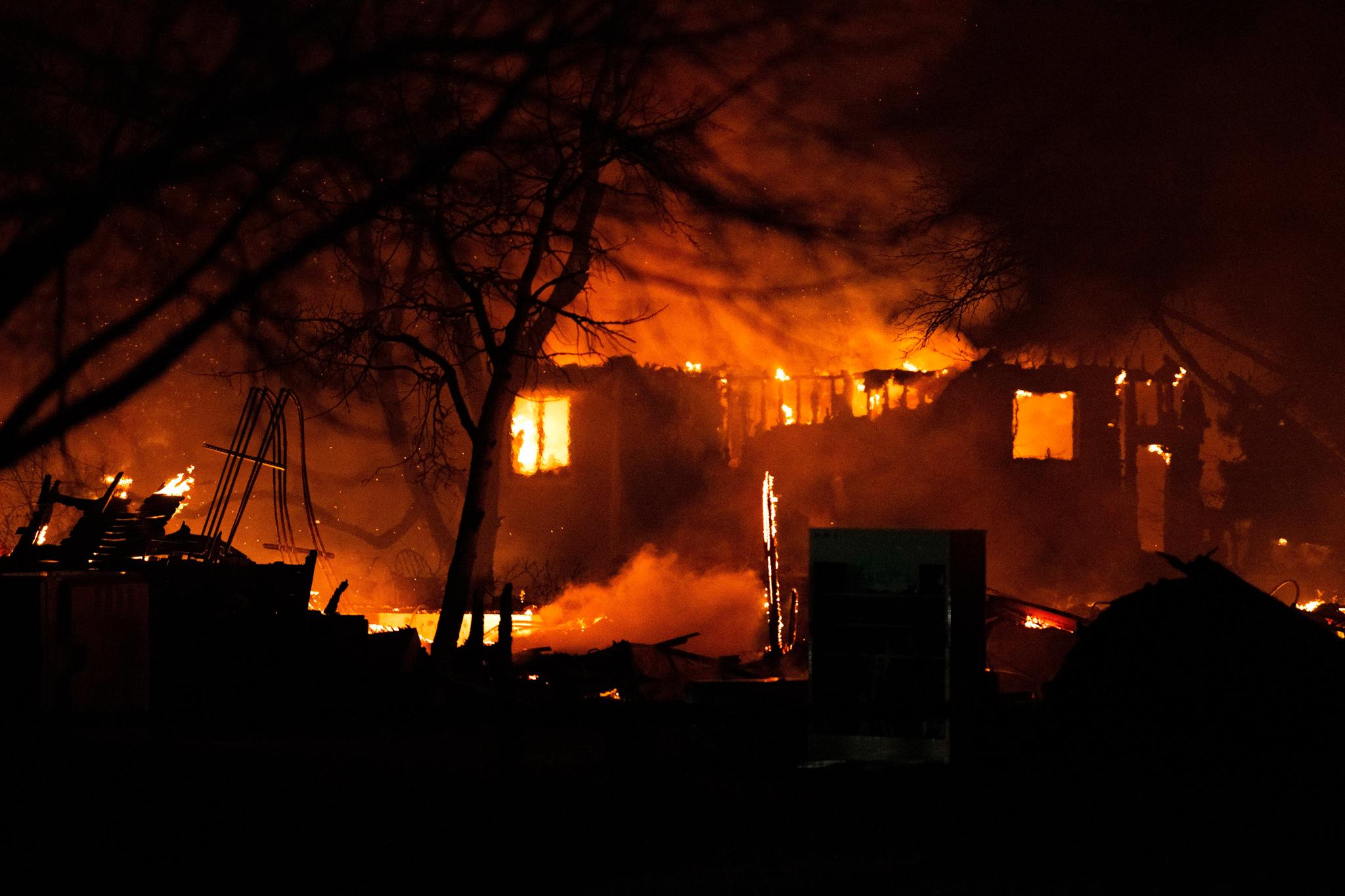 The Marshall Fire engulfs a home in Louisville, Colo., Dec. 30, 2021, as crews worked through the night battling the blaze that had destroyed more than 500 home in Boulder County.