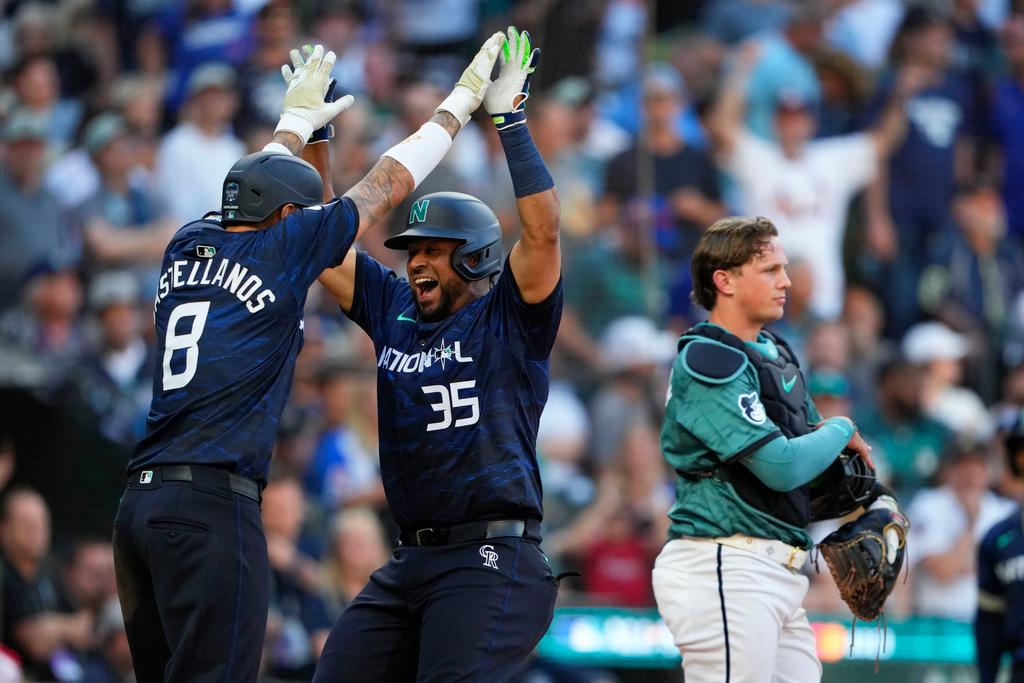 National League's Elias Díaz, of the Colorado Rockies (35), celebrates his two run home run with Nick Castellanos (8), of the Philadelphia Phillies, in the eighth inning during the MLB All-Star baseball game in Seattle