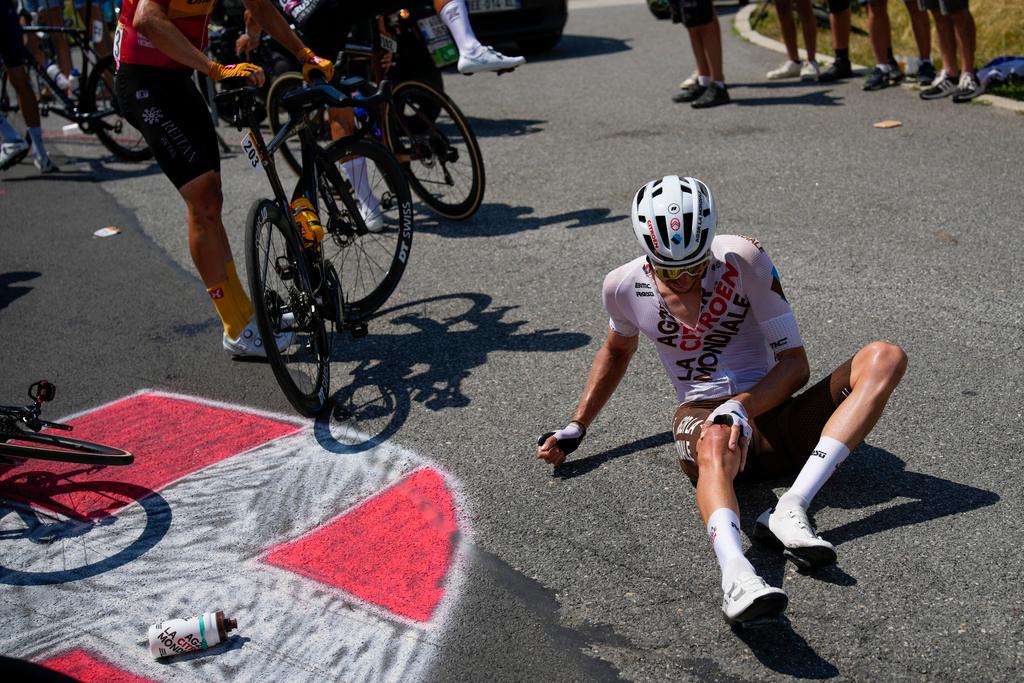 A rider lies on the tarmac after a crash in the pack during the fifteenth stage of the Tour de France cycling race