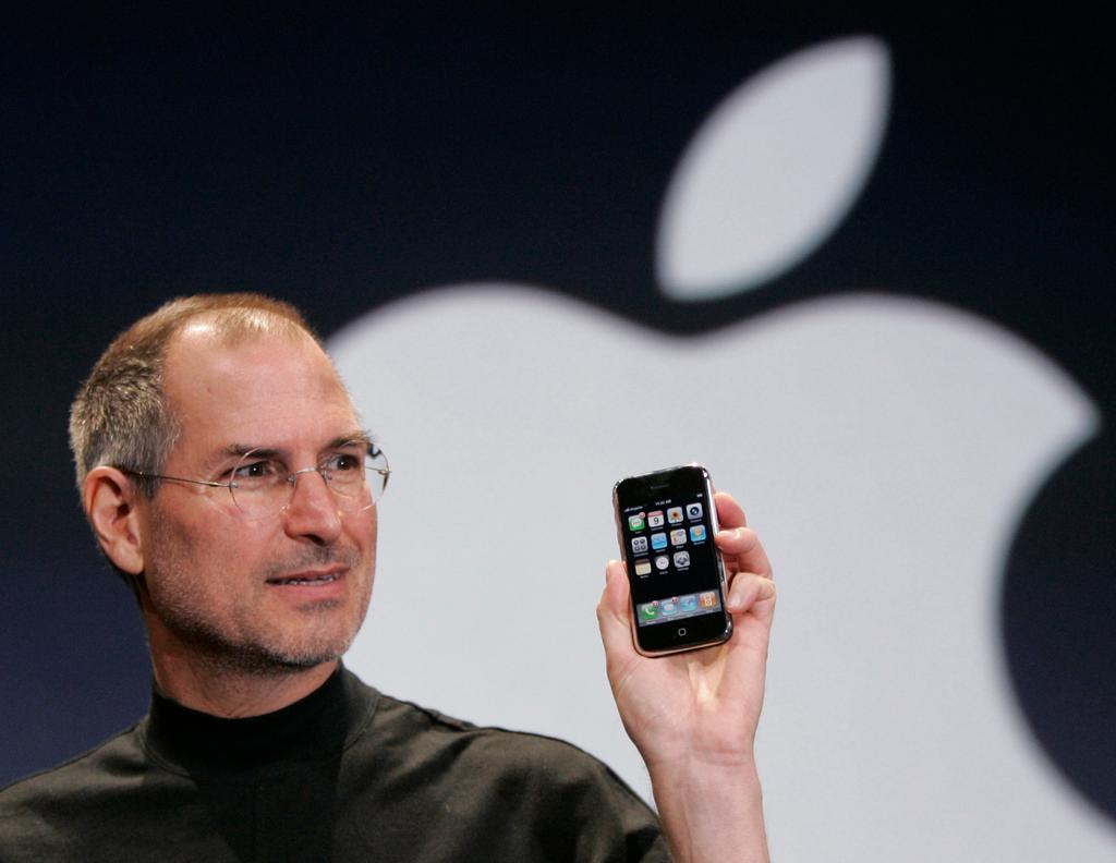 (2007) Apple CEO Steve Jobs holds up an Apple iPhone at the MacWorld Conference
