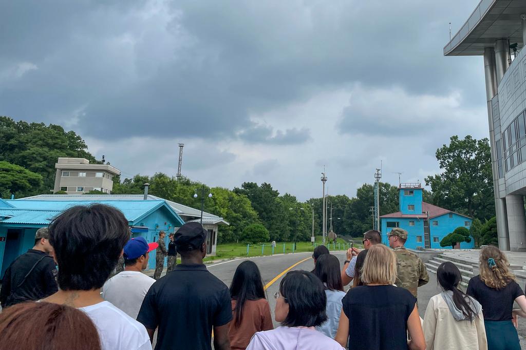 A group of tourists stand near a border station at Panmunjom in the Demilitarized Zone in Paju, South Korea, Tuesday, July 18, 2023.
