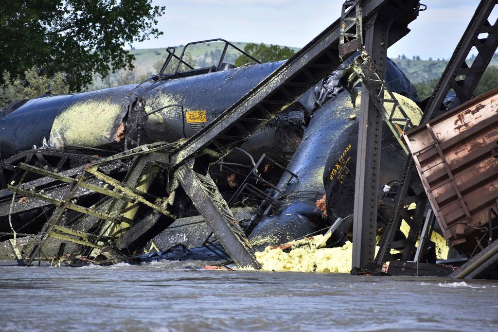 Several train cars are immersed in the Yellowstone River after a bridge collapse near Columbus, Montana