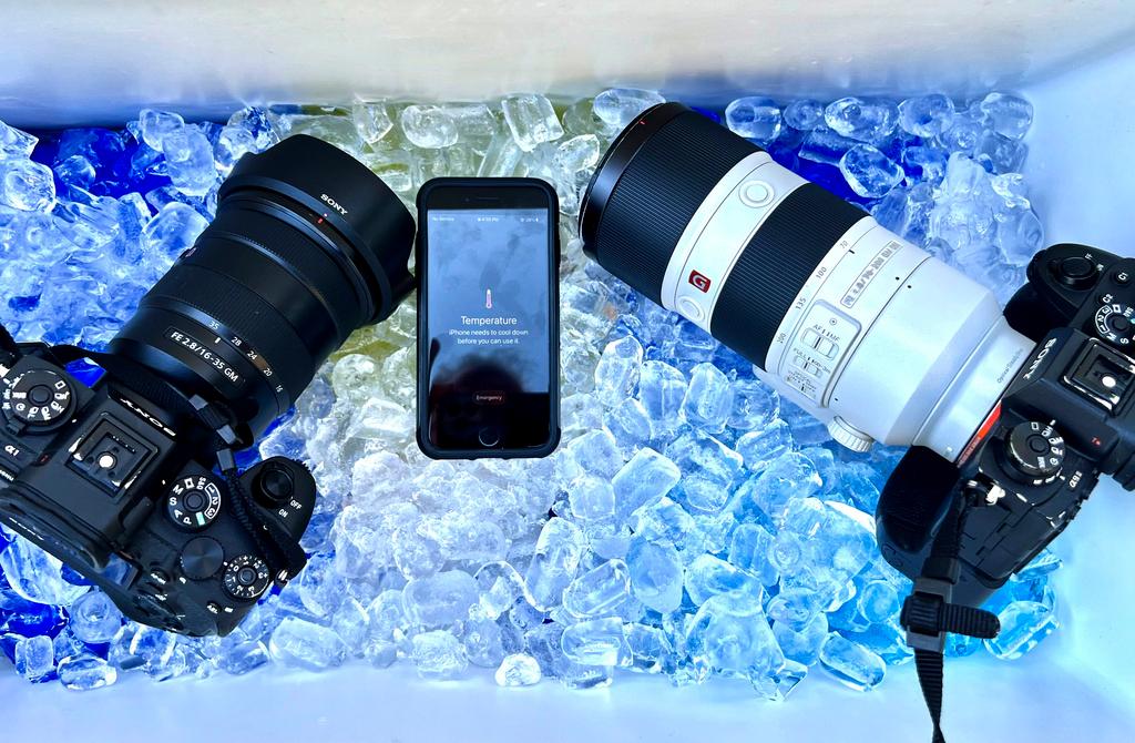 The cameras and cell phone of Associated Press photographer Ross Franklin sit on ice after the devices stopped working after overheating in Tempe, Ariz. 