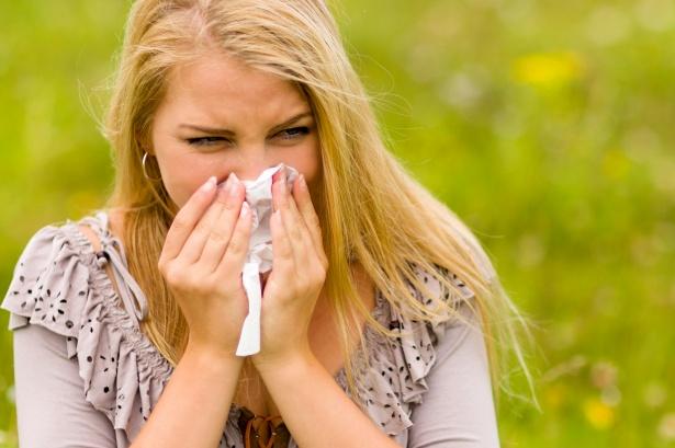 Woman blowing nose