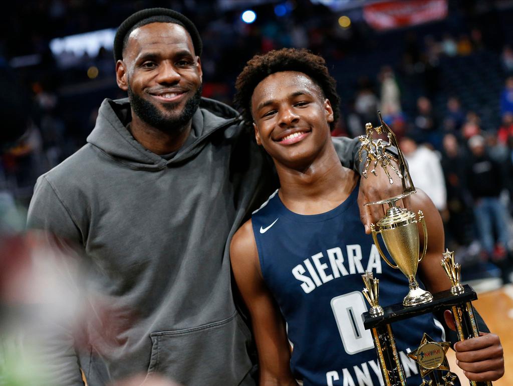 LeBron James, left, poses with his son Bronny after Sierra Canyon beat Akron St. Vincent - St. Mary in a high school basketball game, Saturday, Dec. 14, 2019, in Columbus, Ohio