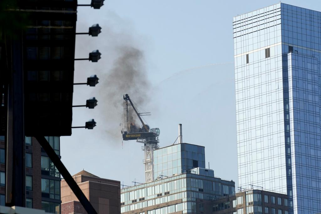 moke rises from a construction crane that caught fire in Manhattan, Wednesday, July 26, 2023, in New York.