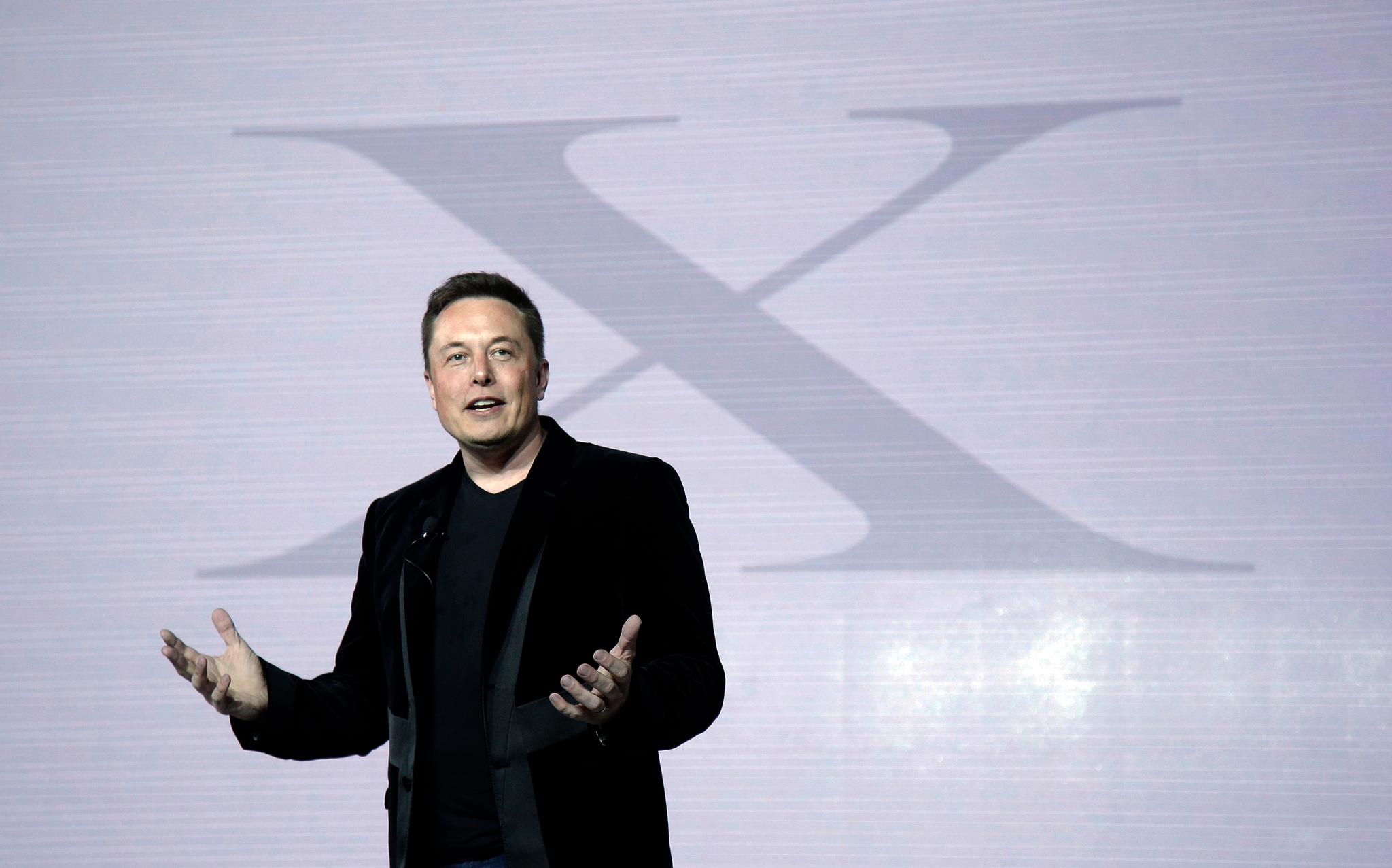 Elon Musk, CEO of Tesla Motors Inc., introduces the Model X car at the company's headquarters Tuesday, Sept. 29, 2015, in Fremont, Calif.
