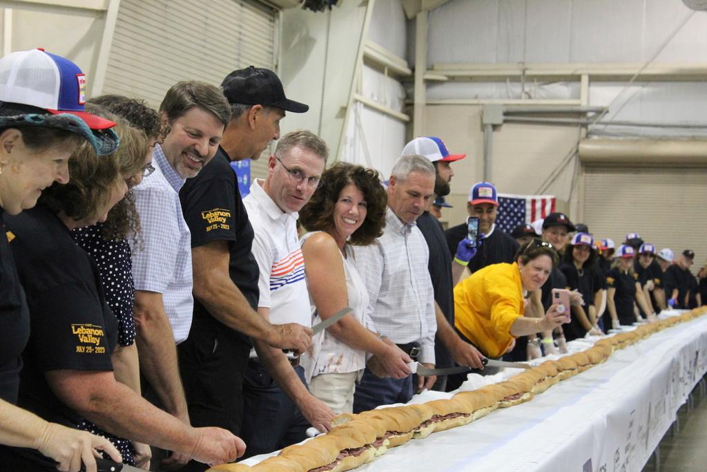 Volunteers help assemble the 150-foot-long (45.7-meters-long) bologna sandwich at the Lebanon Area Fair on Tuesday, July 25, 2023 in Lebanon, Pa.