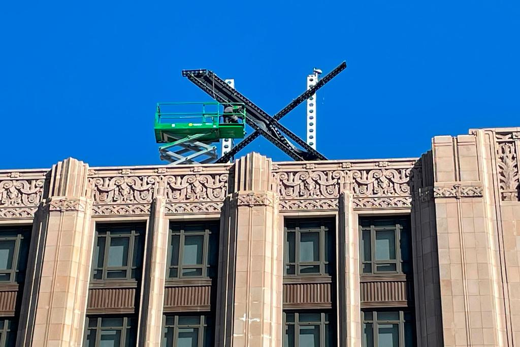 A large, metal "X" sign is seen on top of the downtown building that housed what was once Twitter, now rebranded by its owner, Elon Musk, in San Francisco,