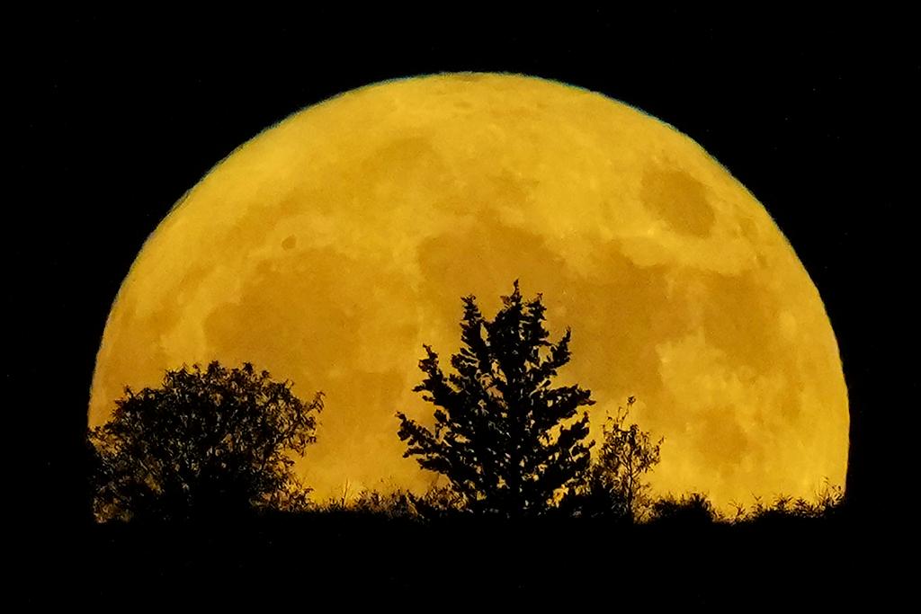 The supermoon rises behind a hill at Pera Chorio Nisou, outskirts of Nicosia, Cyprus