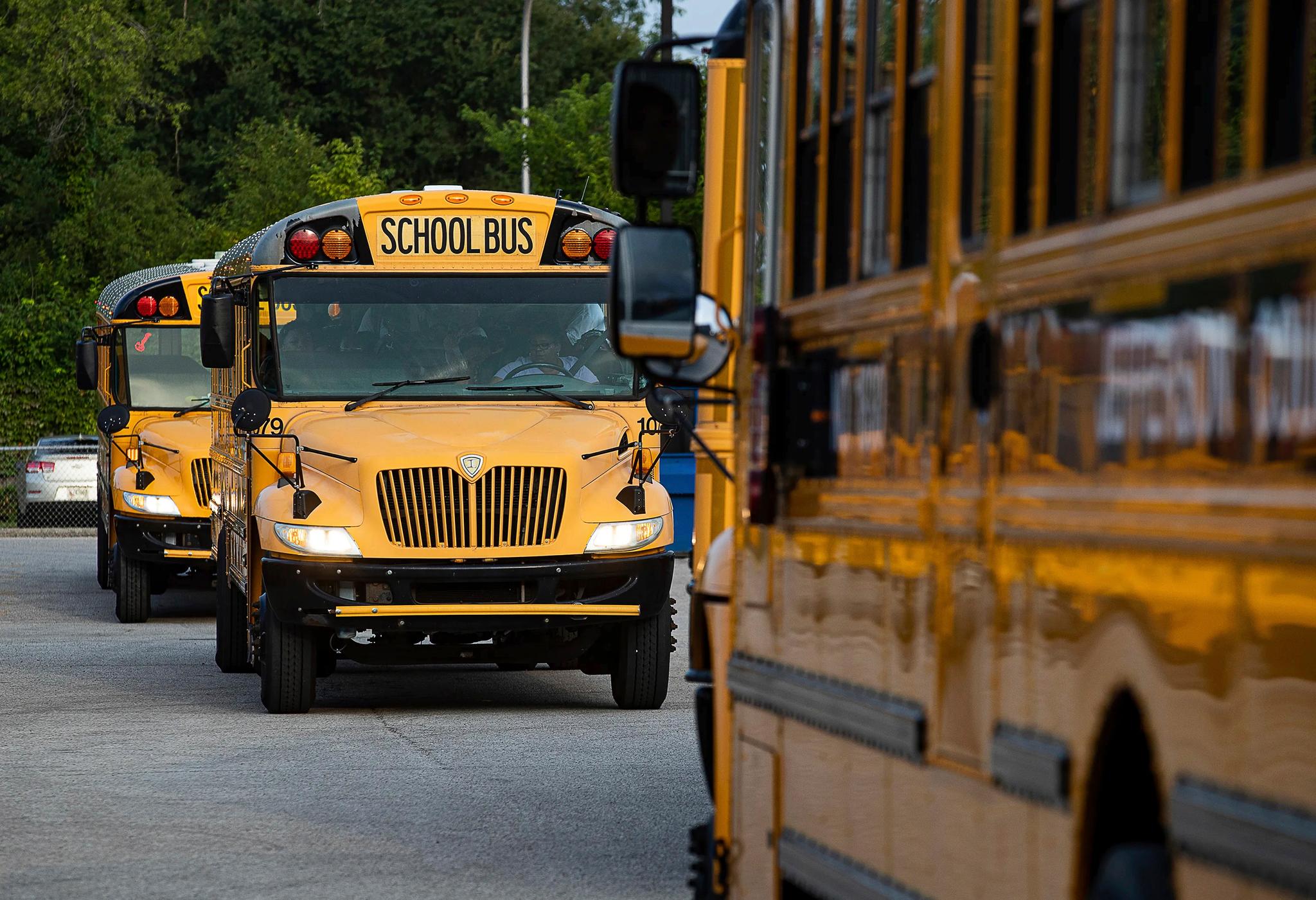 Jefferson County Public Schools buses packed with students make their way through the Detrick Bus Compound on the first day of school, Wednesday, Aug. 9, 2023, in Louisville, Ky.