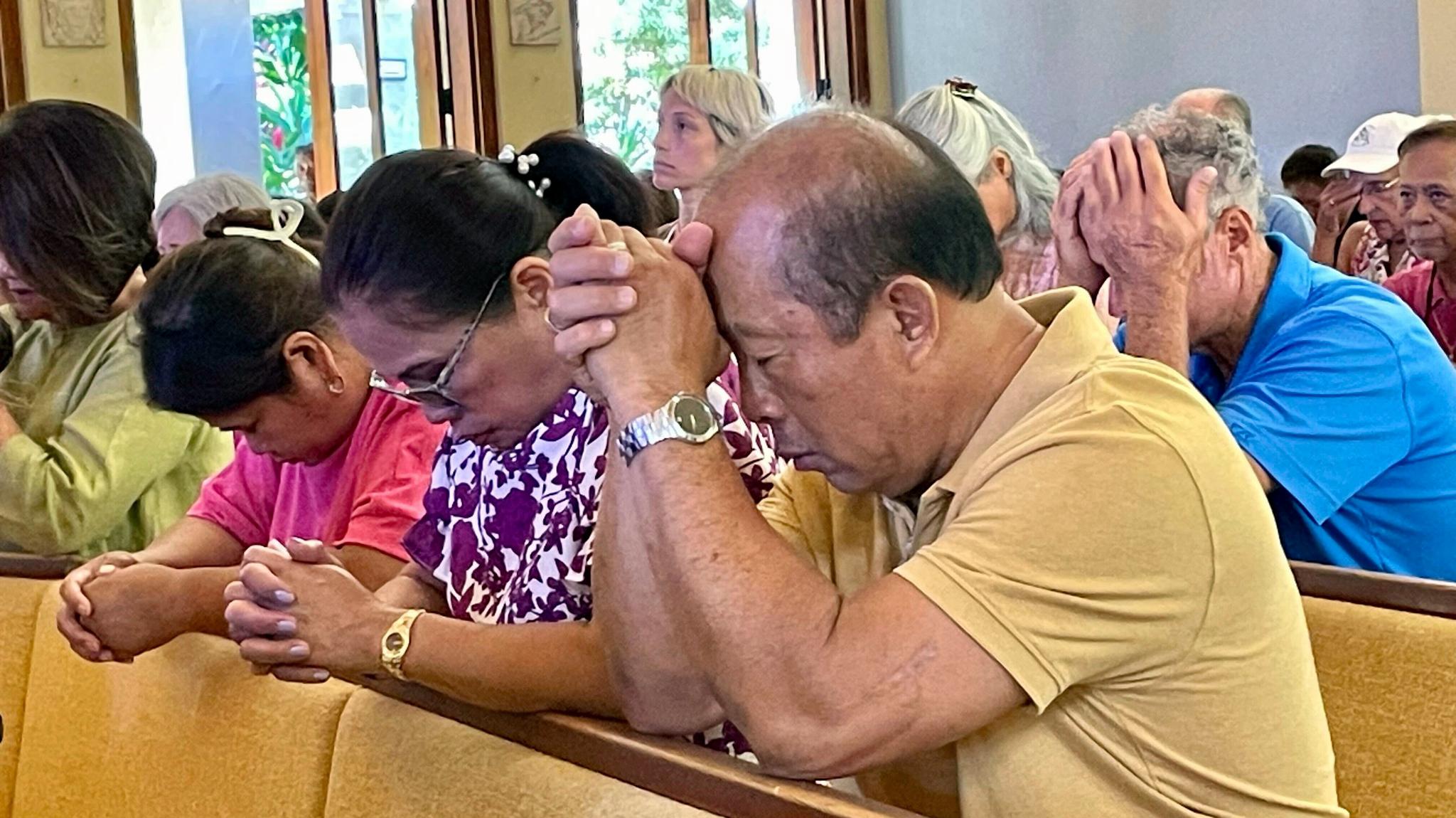 People praying, eyes closed