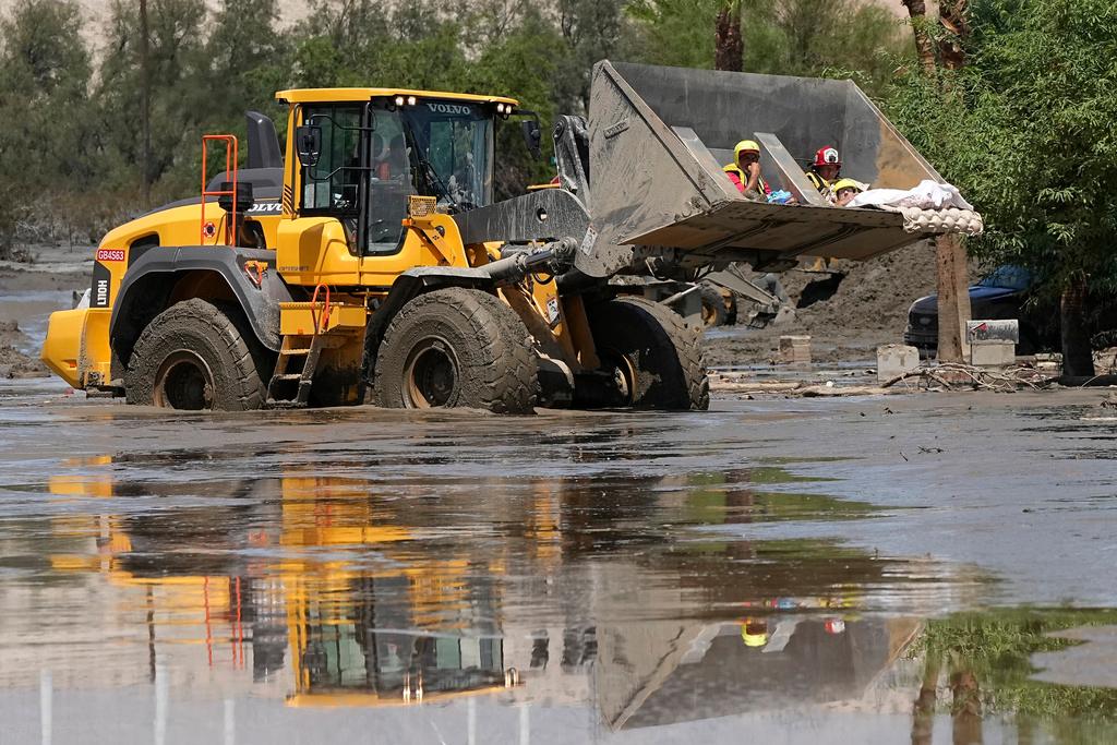 Firefighters use a skip loader to rescue people from an assisted living center 