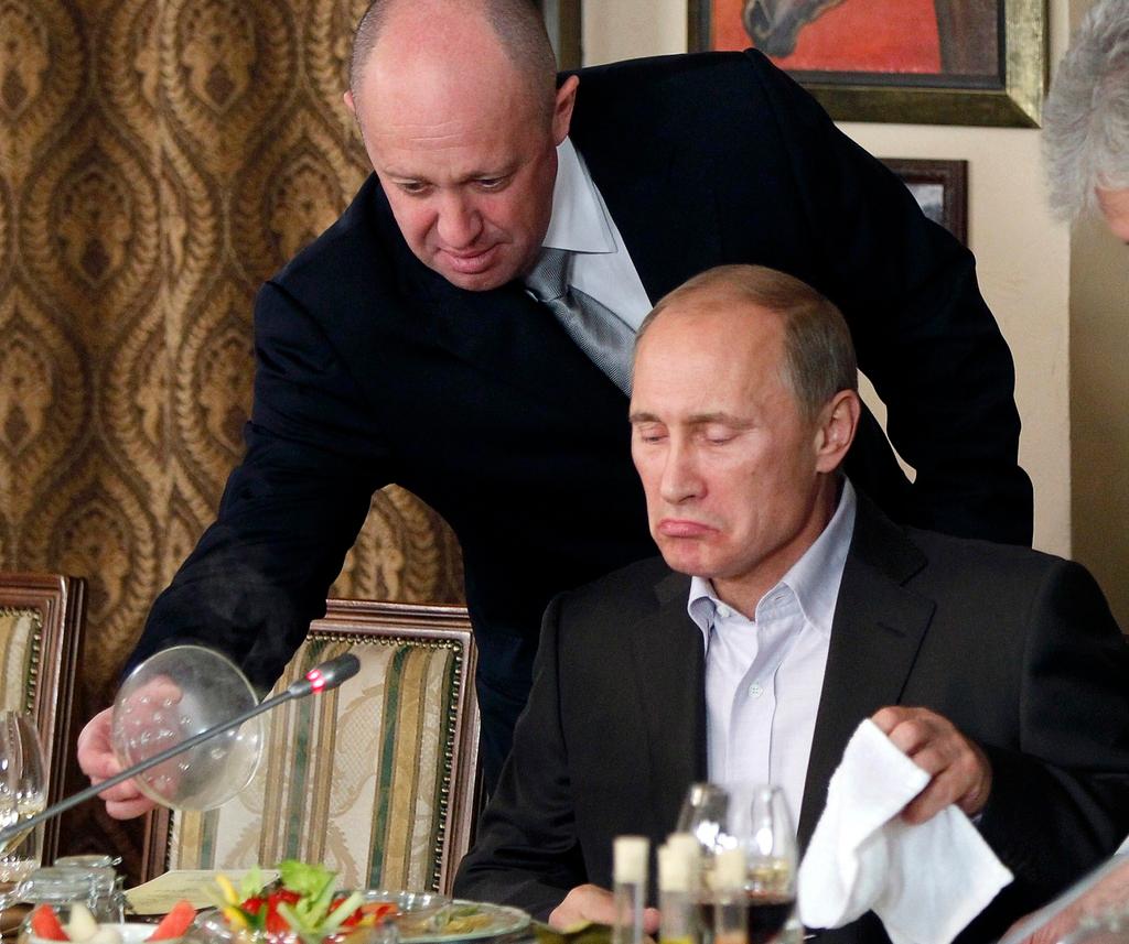 (2011) Yevgeny Prigozhin, top, serves food to Russian Prime Minister Vladimir Putin at Prigozhin's restaurant outside Moscow