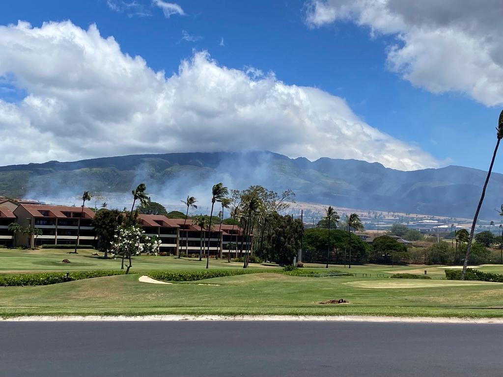 Smoke rises in the hills above the Kaanapali resort hotel area of Lahaina, Hawaii