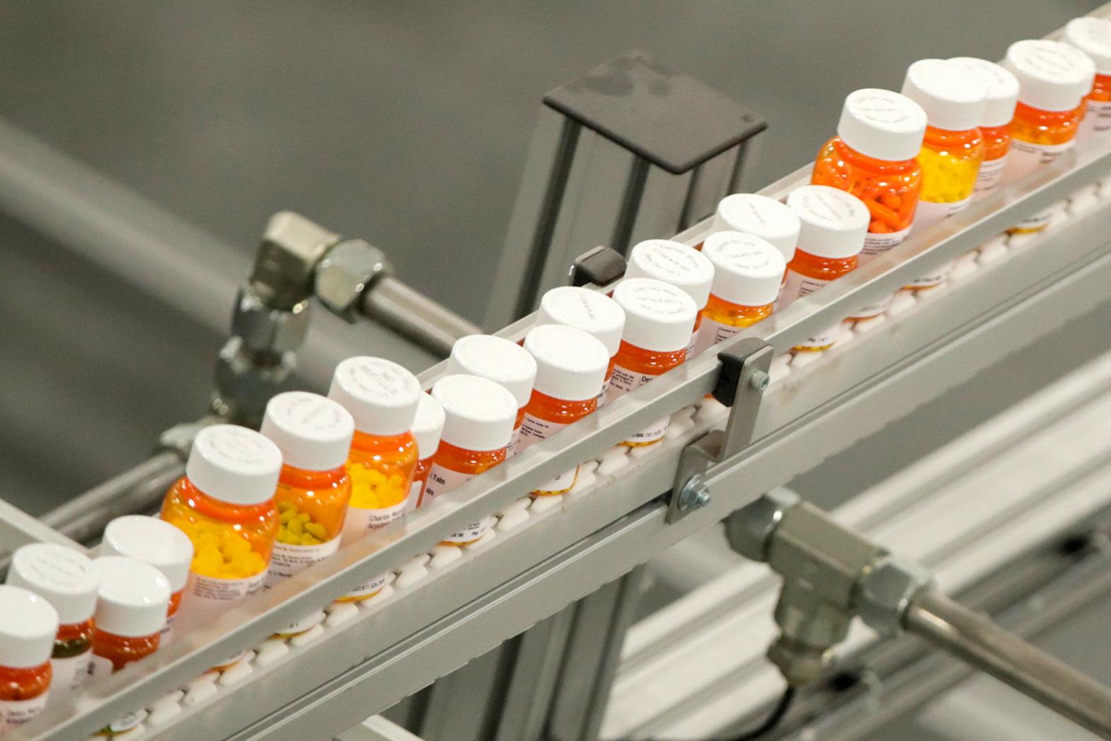 Bottles of prescription pills on a conveyer belt