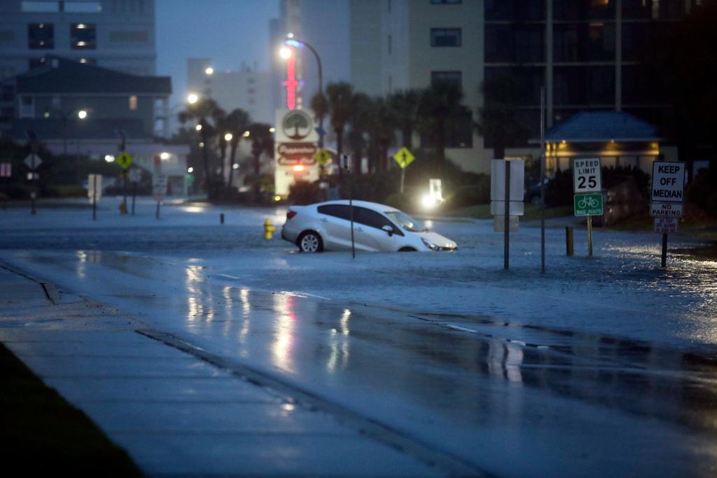 A car plunged into flood waters on Ocean Boulevard in North Myrtle Beach on Wednesday, Aug. 30, 2023 after the passage of Hurricane Idalia.