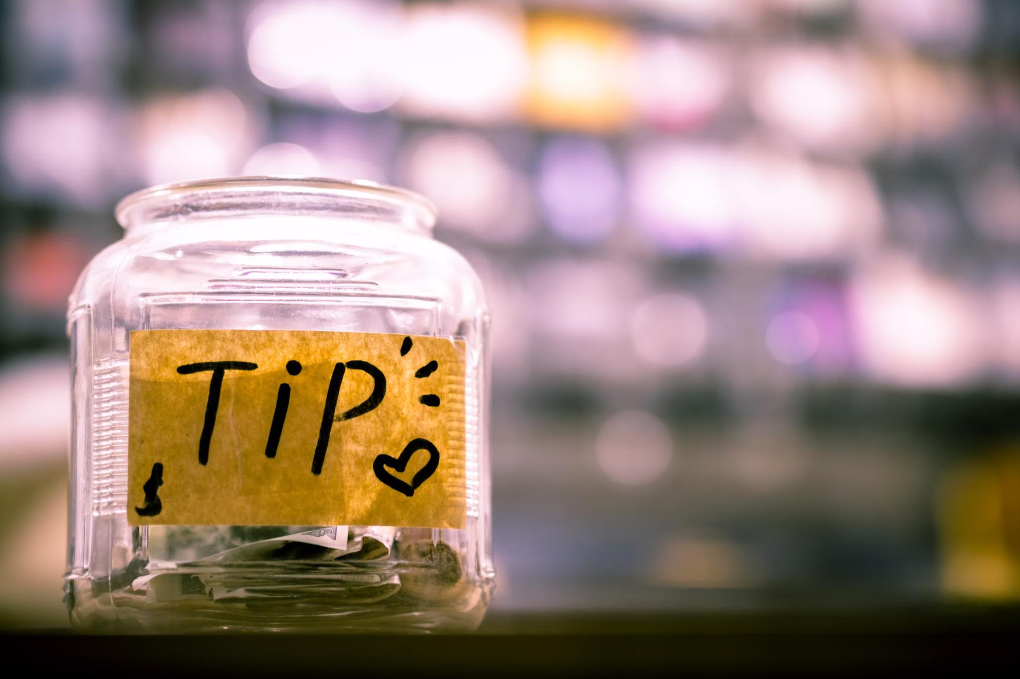 Tip jar with money inside of it
