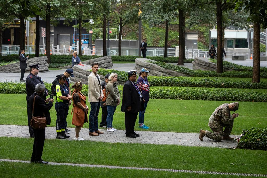 People pray before the commemoration ceremony on the 22nd anniversary of the September 11, 2001, terror attacks 