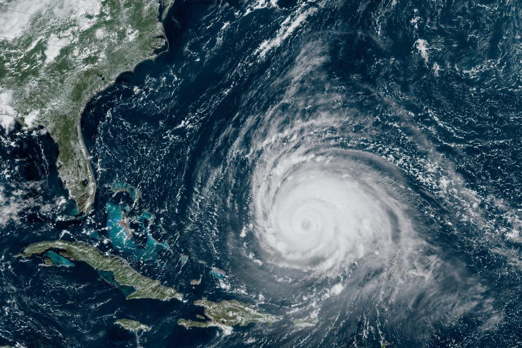 In this satellite image provided by the National Oceanographic and Atmospheric Administration via NASA, Hurricane Lee continues its slow west-northwest trajectory across the Atlantic Ocean on Tuesday, Sept. 12, 2023. 