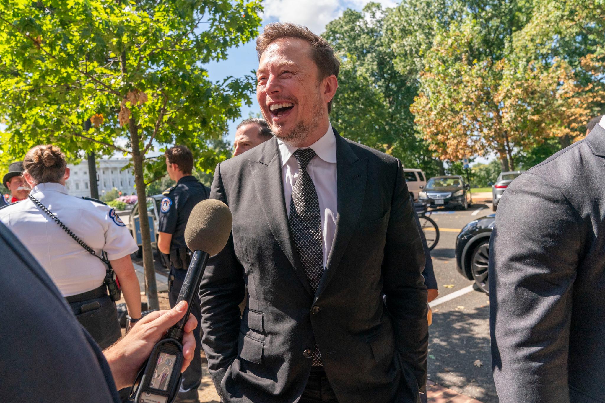 Elon Musk, CEO of X, the company formerly known as Twitter, laughs while speaking to the media after attending a closed-door gathering of leading tech CEOs to discuss the priorities and risks surrounding artificial intelligence and how it should be regulated, on Capitol Hill in Washington, Wednesday, Sept. 13, 2023.