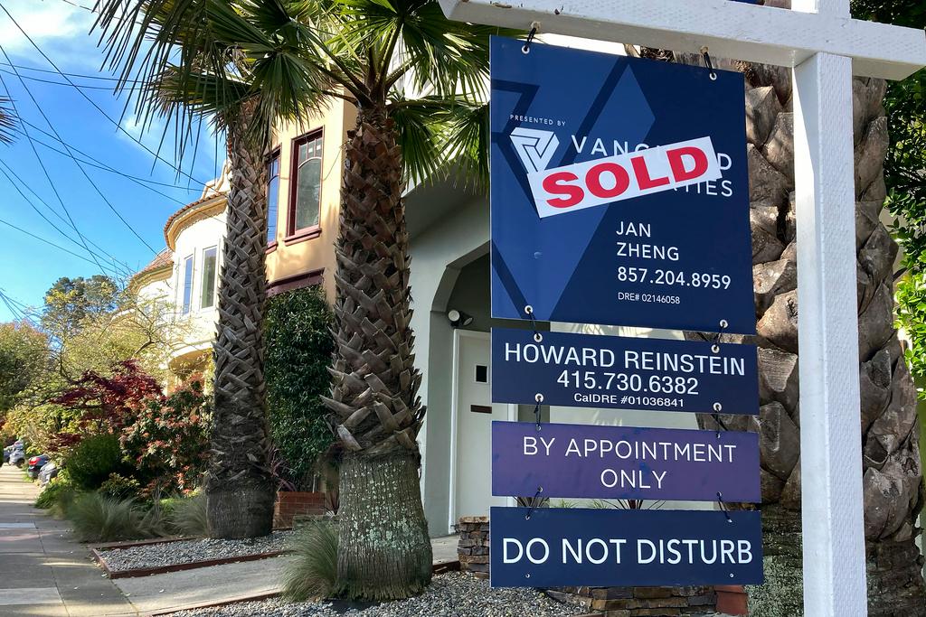 A notice indicating that a home has been sold appears on a sign in residential section of San Francisco, Friday, April 21, 2023.