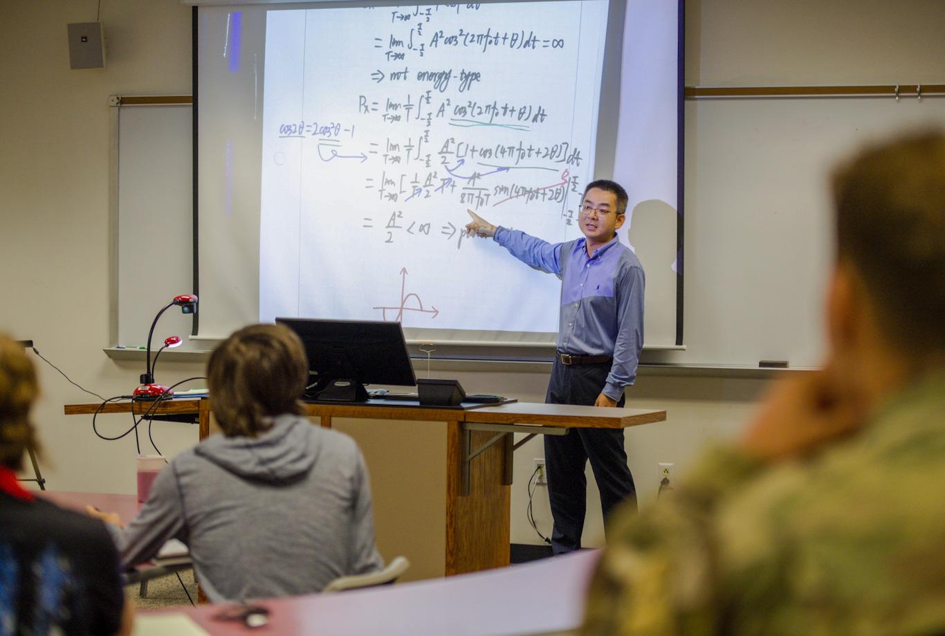 Dr. Edward Meng points out equation on the board to students in his linear systems class. It is Meng’s first year at Cedarville.