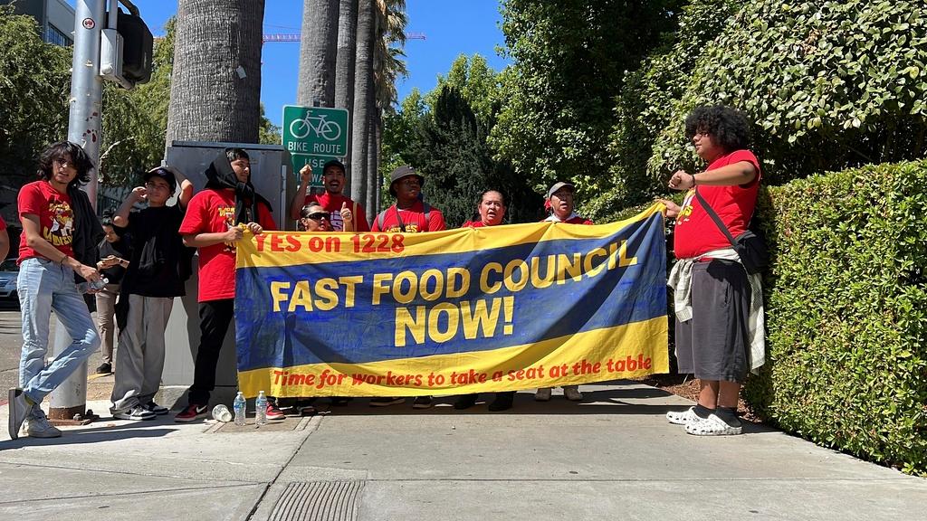  Fast food workers and union activists demonstrate outside the California State Capitol