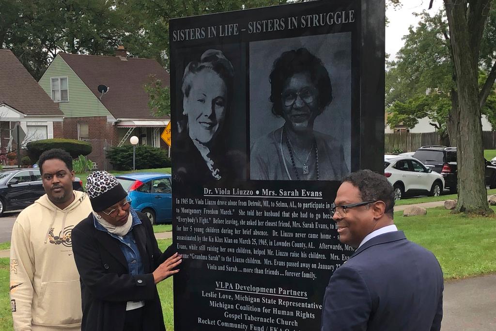 From left, relatives of Sarah Evans and Detroit Deputy Mayor Todd Bettison view 7-foot-tall granite monument commemorating Evans and her friend, Viola Liuzzo 