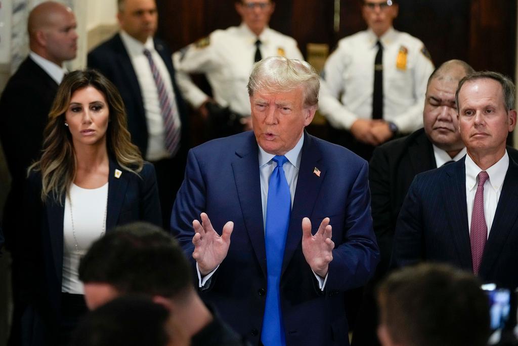 Former President Donald Trump, center, arrives at New York Supreme Court