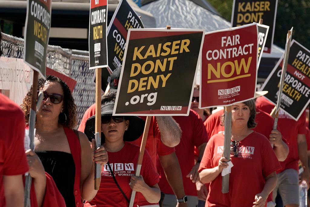 Kaiser Permanente mental health workers and supporters march outside a Kaiser facility in Sacramento, Calif., Aug. 15, 2022.