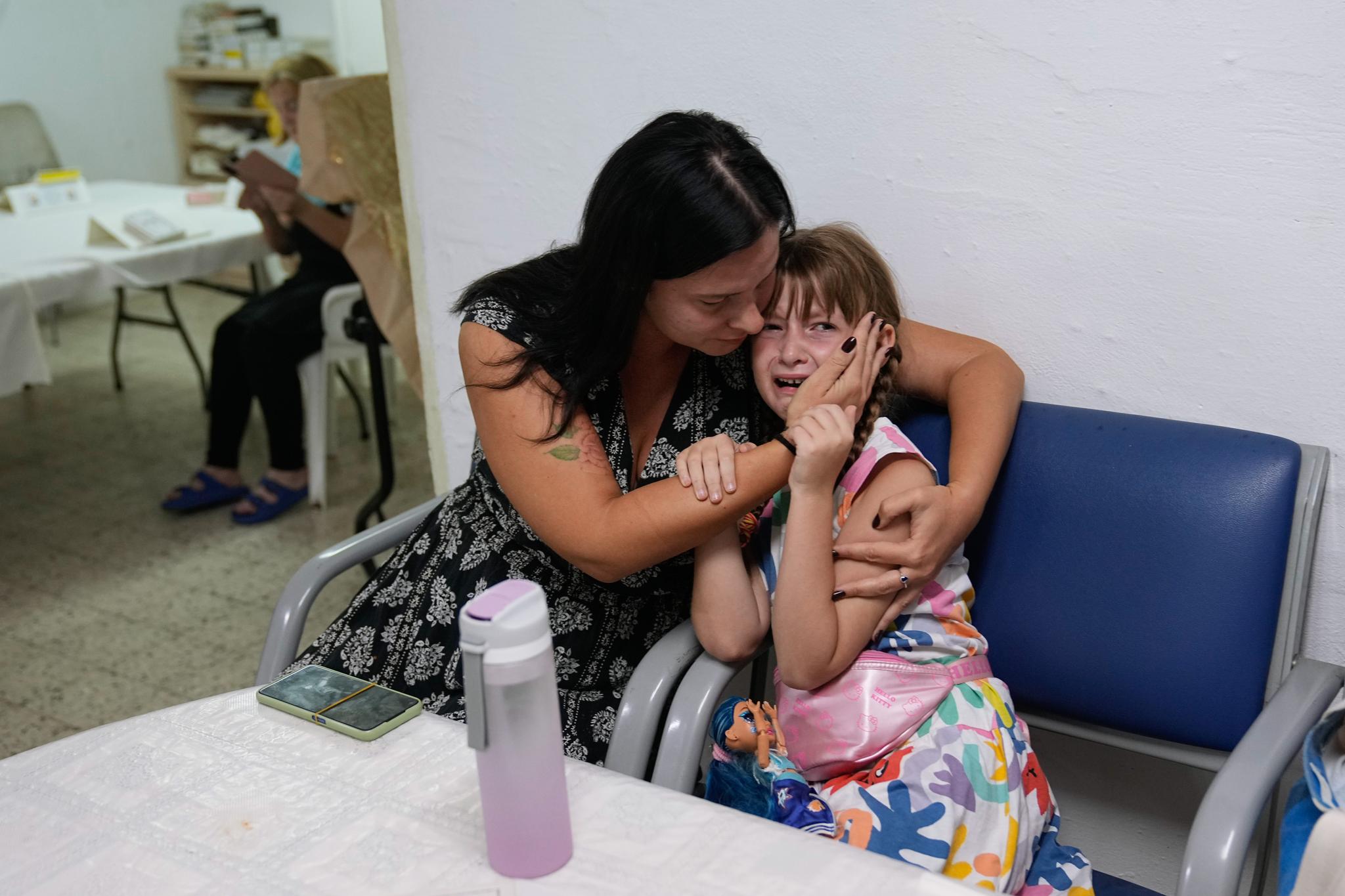 A mom comforts her crying daughter