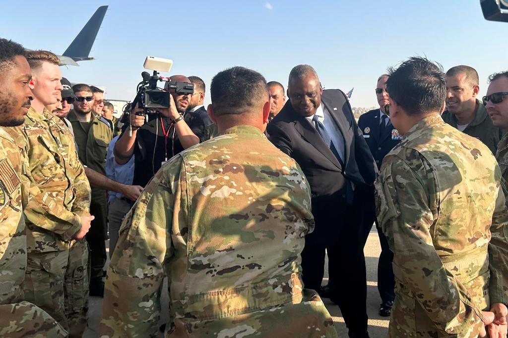 U.S. Defense Secretary Lloyd Austin thanks crew members at the Nevatim Air Base in the desert in Israel