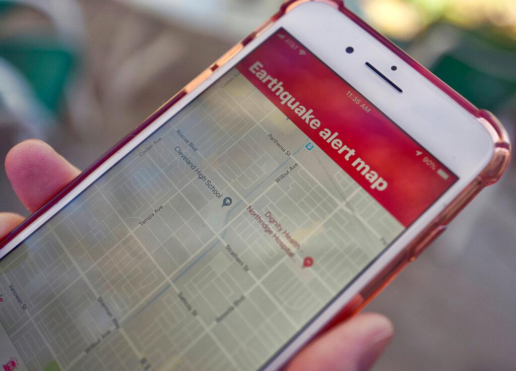 A mobile phone customer looks at an earthquake warning application on an iPhone in Los Angeles on Jan. 3, 2019.