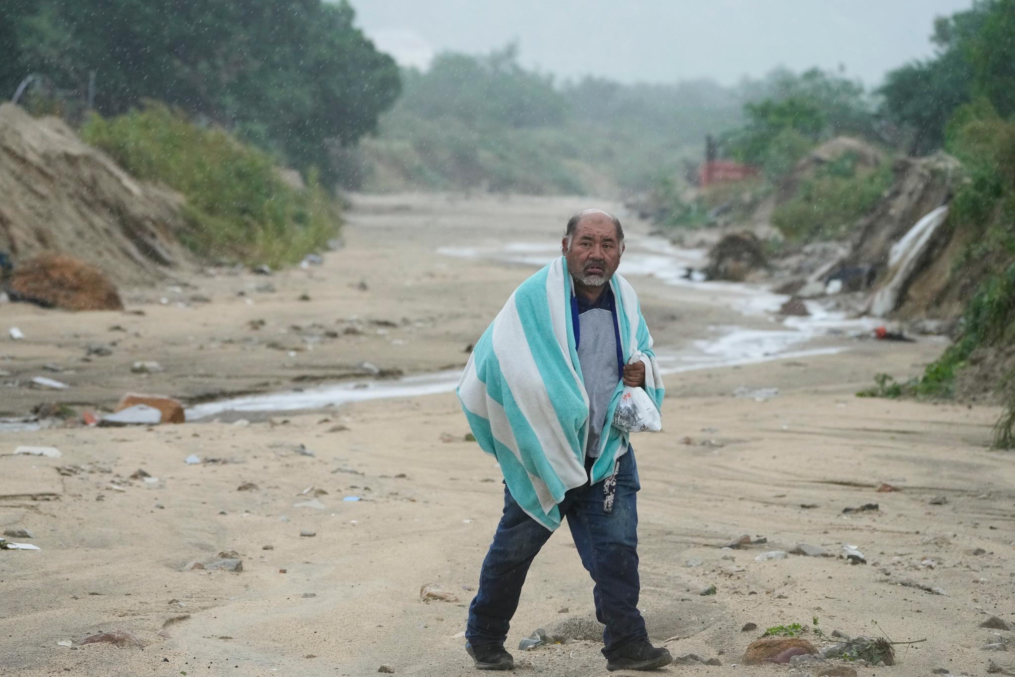 man walks on the mud caused by hurricane