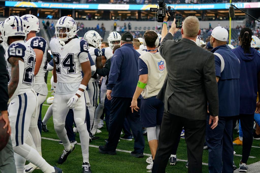 Dallas Cowboys and Los Angeles Chargers players get into a shoving match before an NFL football game Monday, Oct. 16