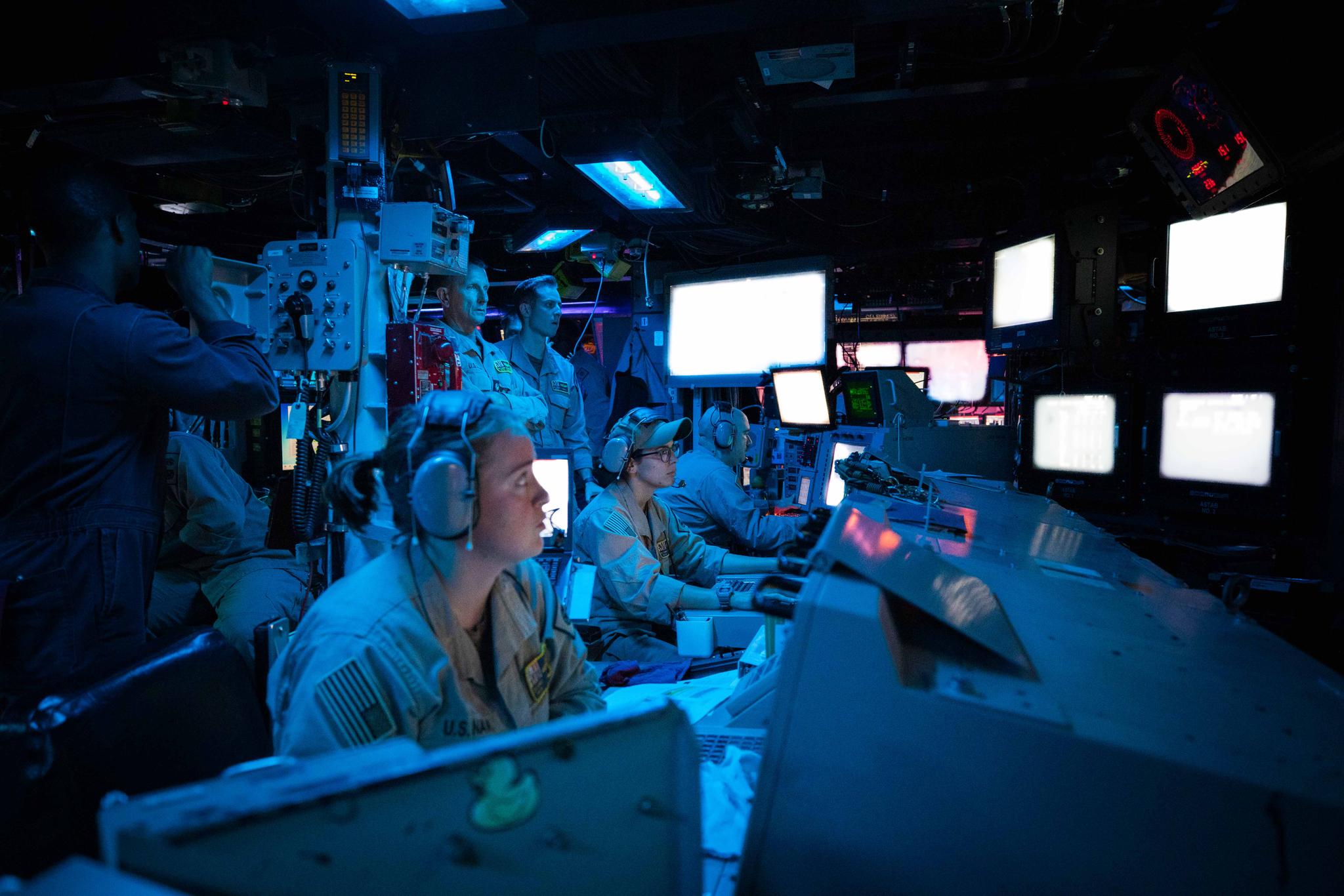 Sailors assigned to the Arleigh Burke-class guided-missile destroyer USS Carney (DDG 64) stand watch in the ship’s Combat Information Center 