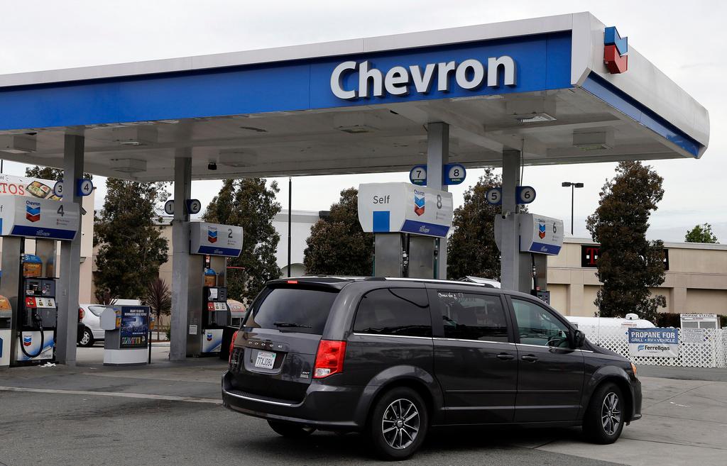  A motorist drives near the pumps at a Chevron gas station in Oakland, Calif., on April 25, 2017.